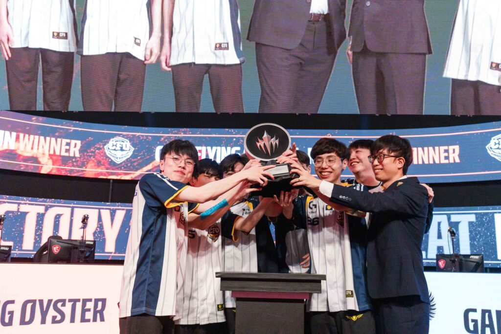 The LoL esports players from the team CTBC Flying Oyster stand on the stage and hold the trophy of the tournament LCP 2025 Mid Season - a photo.