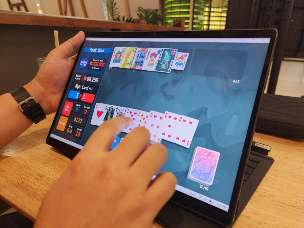 The touchscreen can be used for some casual gaming, like Balatro (Photo via esports.gg)