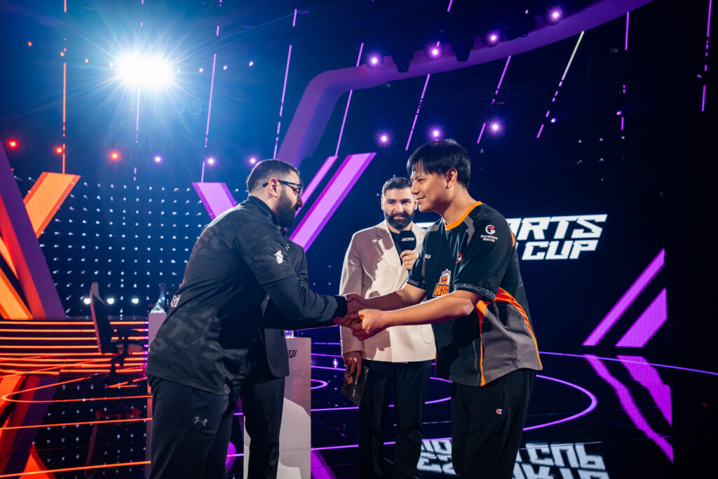 It’s a photo of two fighting games players AngryBird and Xiaohai shaking hands before a match at the Street Fighter 6 Esports World Cup 2025.