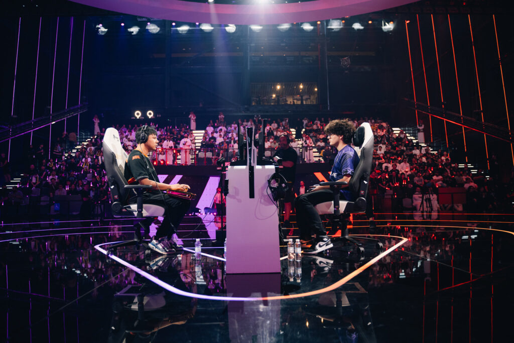 The photo features two Street Fighter 6 players Xiaohai and Blaz at the Esports World Cup 2025 — during the grand final match.