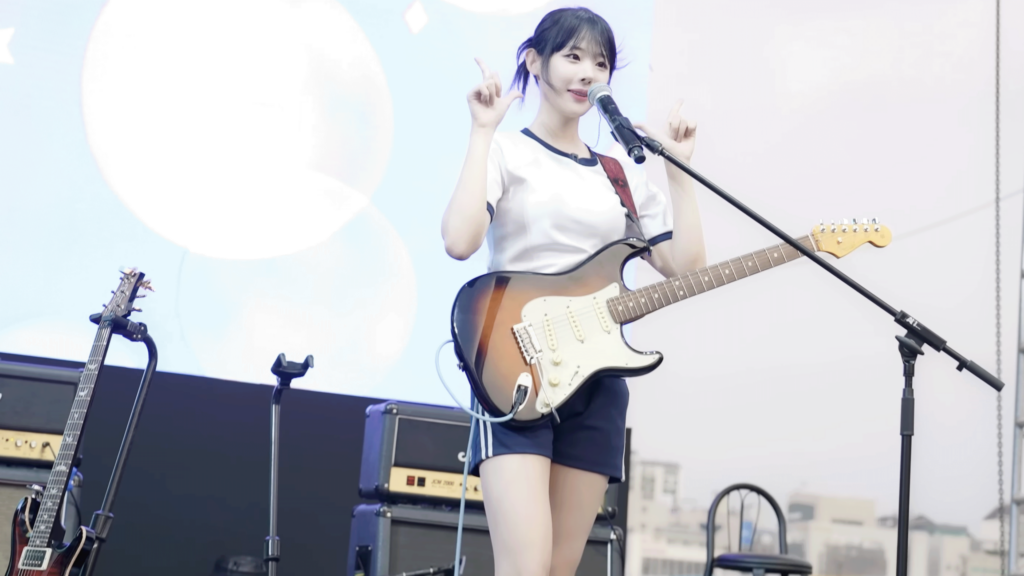 Hina performing on stage with QWER