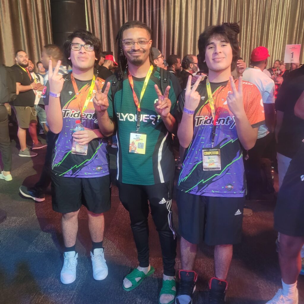It’s a photo of three fighting games players: Scorpionprocs, Nicolas, and Punk.