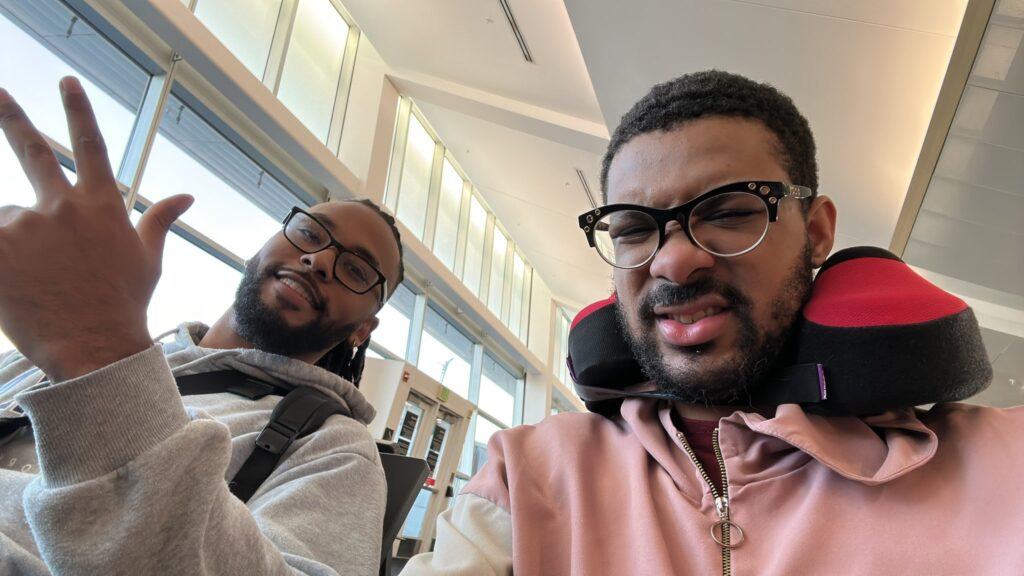 It’s a photo of two Mortal Kombat players SonicFox and Rewind. They are traveling to the tournament Final Kombat 2025.