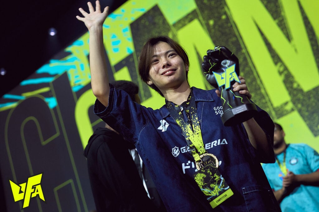 It's a photo of the Street Fighter 6 esports player Sahara holding his SF6 UFA 2025 Trophy.
