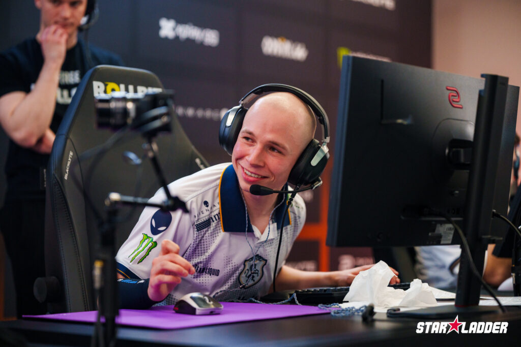 The CS2 esports player EliGE from Team Liquid is smiling in front of his computer during Stage 2 at the StarLadder Budapest Major 2025 - a photo.