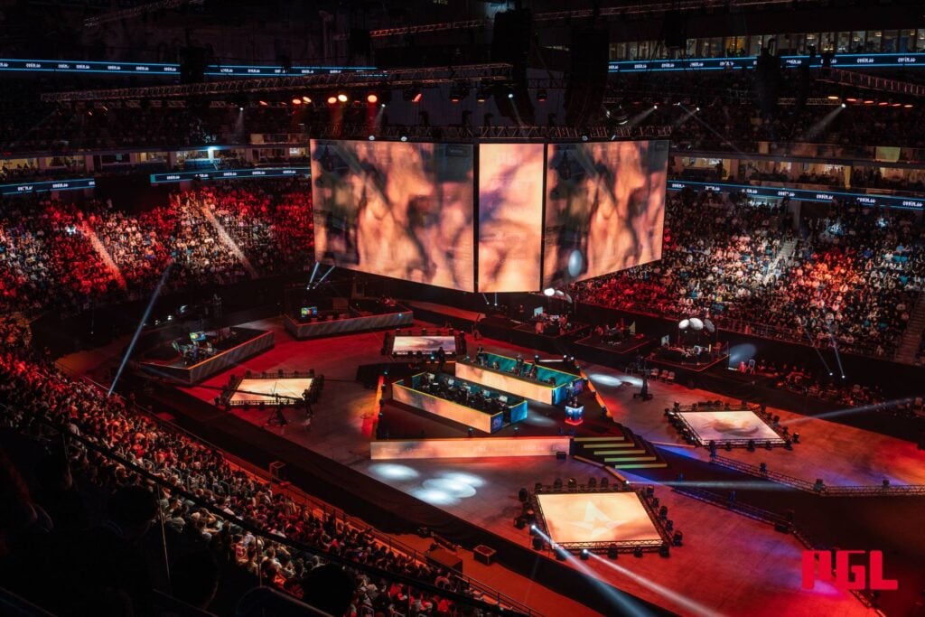 The photo features the arena, full of people, during the CS2 esports event PGL Astana 2025.