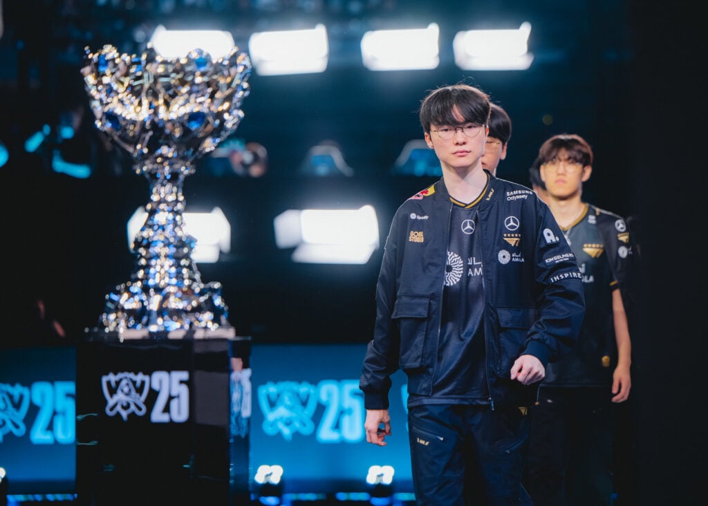 It's a photo of the League of Legends esports players from the team T1, including Faker, on the stage during the LoL Worlds 2025 semifinal.