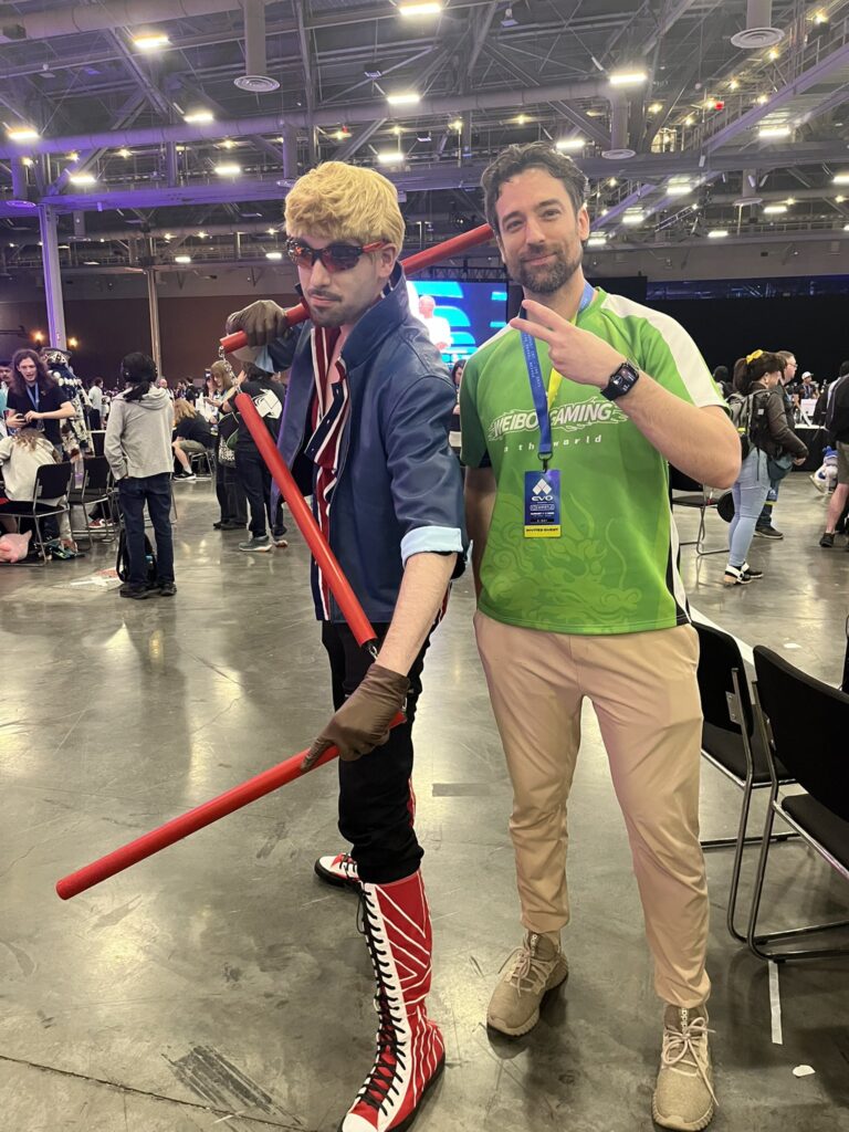 The fighting games content creator and esports player Diaphone at Evo Las Vegas 2025 with a Billy Kane cosplayer.