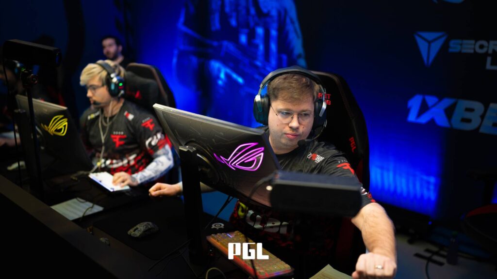 It’s a photo of Counter-Strike 2 esports player Finn "karrigan" Andersen from the team FaZe Clan during the Swiss Stage of the CS2 tournament PGL Cluj-Napoca 2026 — in front of a monitor, greeting a teammate during a match.