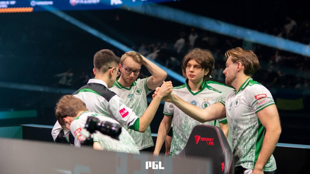 It’s a photo of Counter-Strike 2 players from Team Falcons during the Playoffs at the CS2 esports tournament PGL Cluj-Napoca 2026 — on the stage after a match, somewhat sad, supporting each other emotionally.