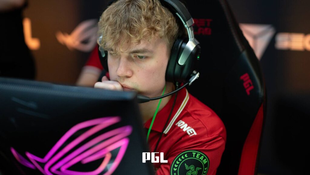 It’s a photo of Counter-Strike 2 player Ludvig "Brollan" Brolin from the team MOUZ during the Swiss Stage of the CS2 esports tournament PGL Cluj-Napoca 2026 — in front of a monitor, focused during a match.