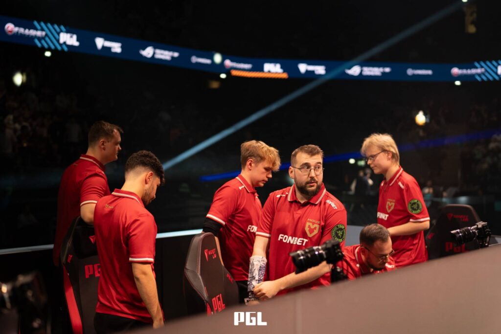 It’s a photo of Counter-Strike 2 players from the team MOUZ during the Playoffs at the CS2 esports tournament PGL Cluj-Napoca 2026 — sad after losing a match, getting ready to leave the stage.