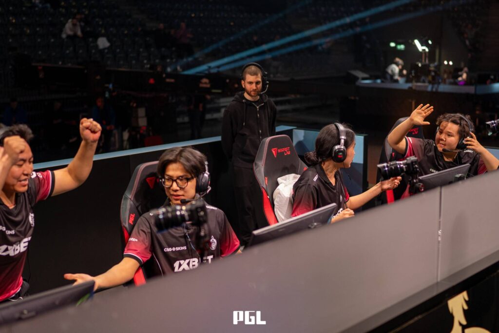 It’s a photo of Counter-Strike 2 players from the team The MongolZ during the Playoffs at the CS2 esports tournament PGL Cluj-Napoca 2026 — in front of monitors, greeting each other after winning a match.