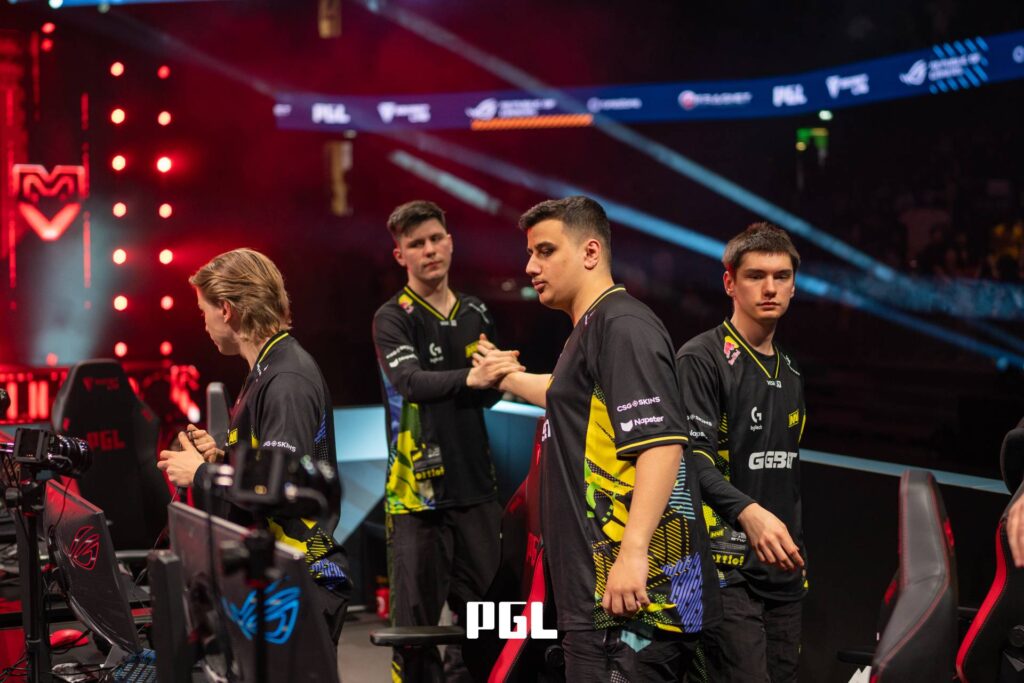 It’s a photo of Counter-Strike 2 players from the team NAVI during the Playoffs at the CS2 esports tournament PGL Cluj-Napoca 2026 — on the stage after a match, support each other emotionally.