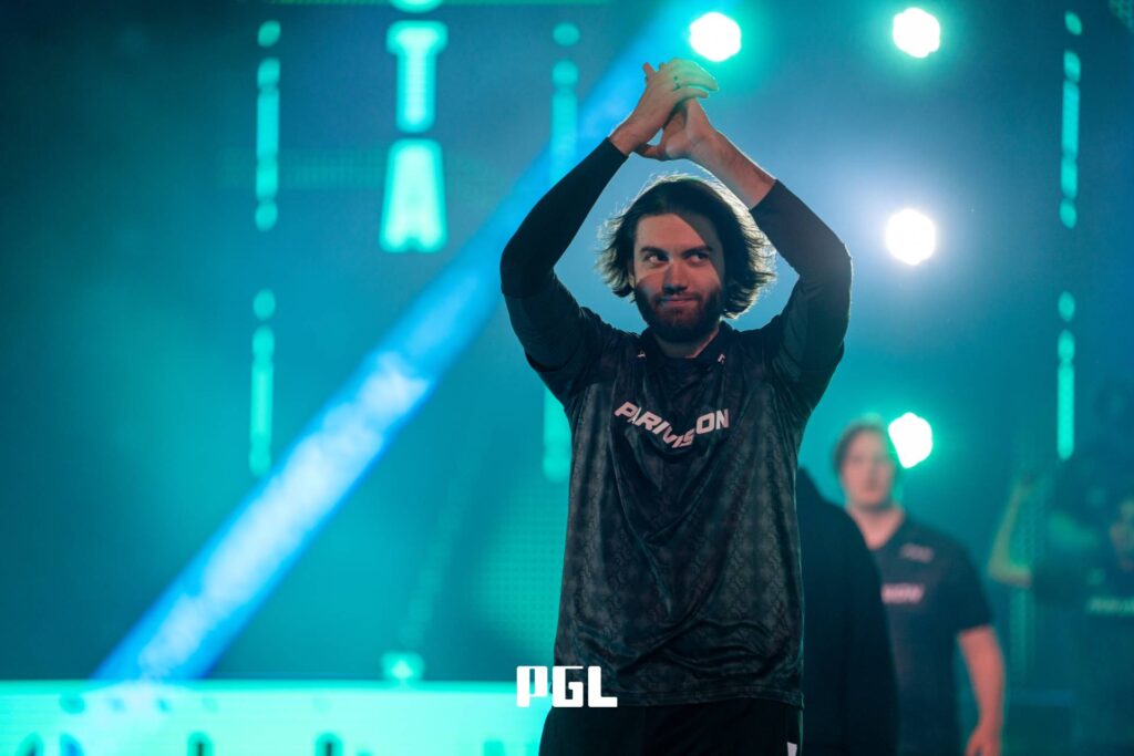 It’s a photo of Counter-Strike 2 player Dzhami "Jame" Ali from the team PARIVISION during the Playoffs the CS2 esports tournament PGL Cluj-Napoca 2026 — walking to the stage, greets the crowd with his hands up.