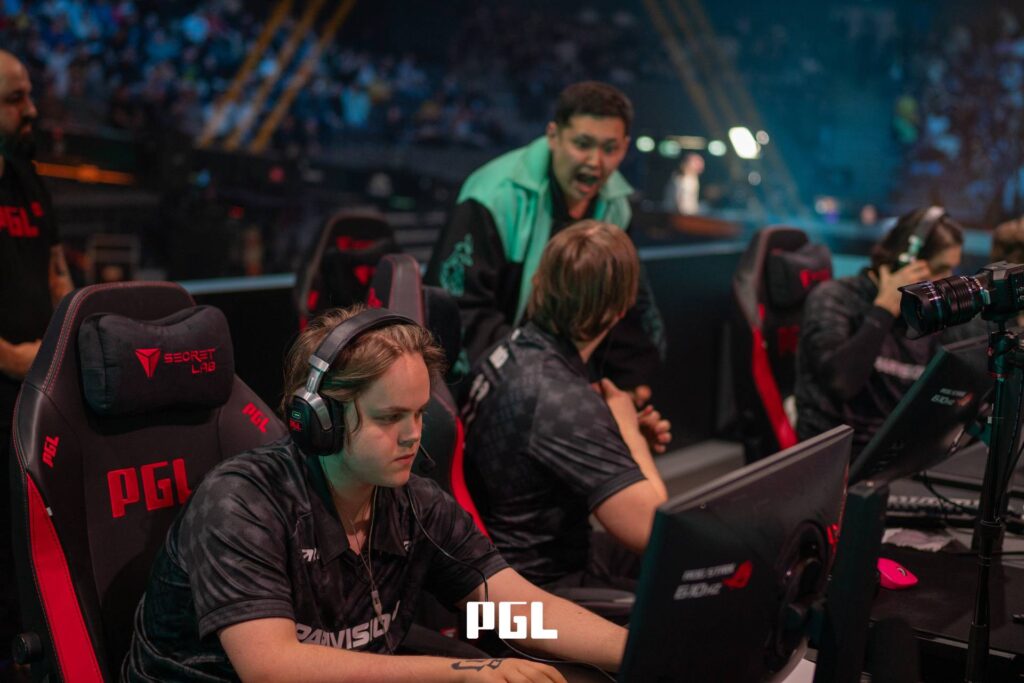 It’s a photo of Counter-Strike 2 players from the team PARIVISION during the Playoffs at the CS2 esports tournament PGL Cluj-Napoca 2026 — in front of monitors, on the stage after winning a match.