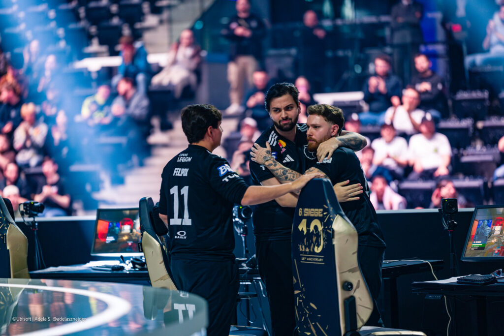 The Rainbow Six Siege X pro players from the team FIRIA during the Finals stage at the esports tournament Six Invitational 2026 — a photo, comfort each other after losing a match versus Fluxo W7M.