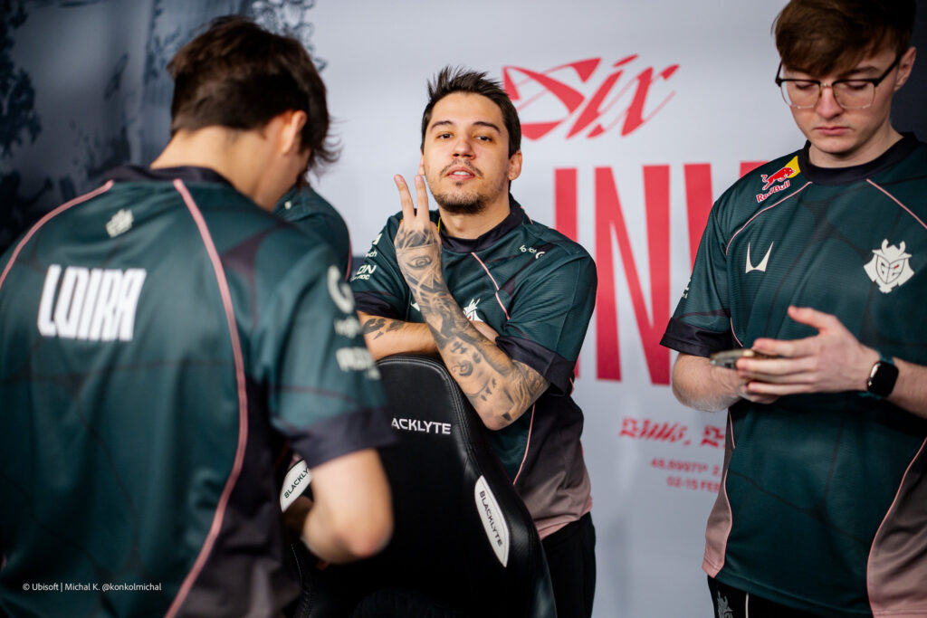 The Rainbow Six Siege X pro players from the team G2 Esports during the Playoffs stage at the esports tournament Six Invitational 2026 — a photo, relaxed near computers before a match.