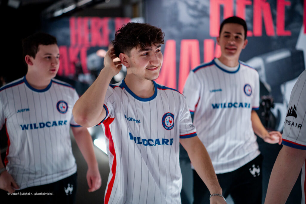 It’s a photo of the Rainbow Six Siege X esports players from team Wildcard during the Playoffs stage of the tournament Six Invitational 2026: walking through the game zone in the studio after winning a match and greeting their opponents.