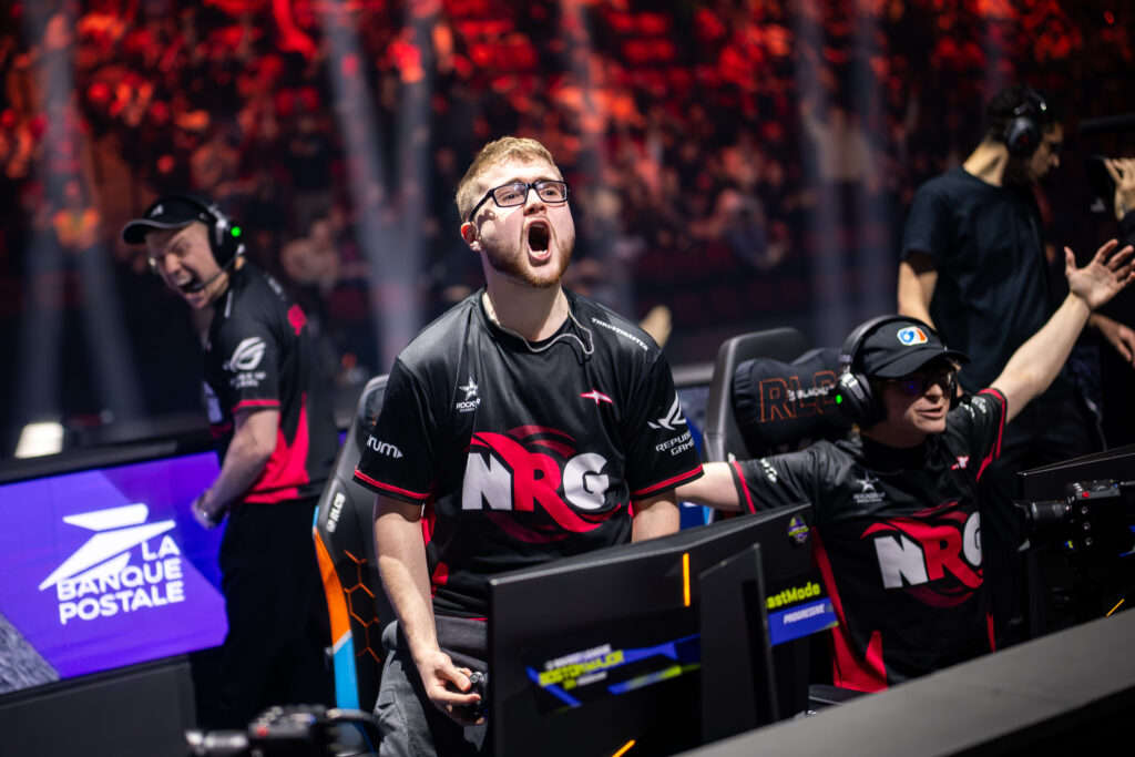 It’s a photo of the Rocket League esports players from the team NRG: on the stage of the tournament RLCS 2026 Boston Major, excited after winning the quarterfinal against Karmine Corp.