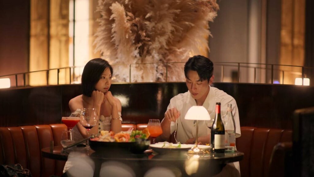 The image features two participants of Single’s Inferno Season 5: Kim Go-eun and Jo I-geon during their Paradise date. 