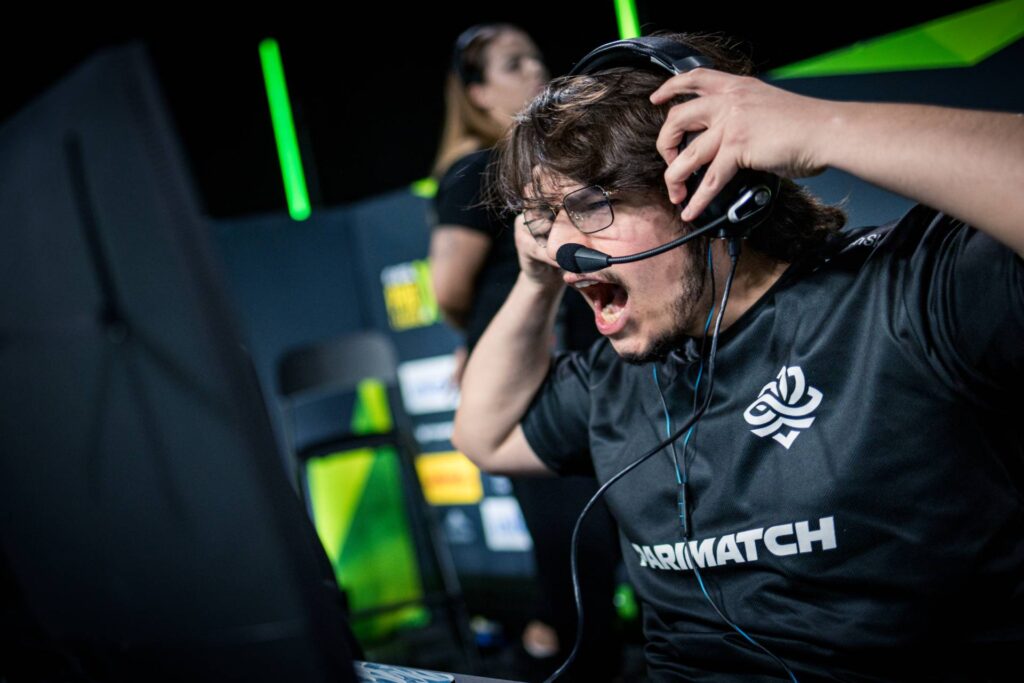 It’s a photo of the CS2 player Eduardo "dumau" Wolkme from the team Legacy during the Counter-Strike esports tournament IEM Kraków 2026 — screams with excitement after winning a match.