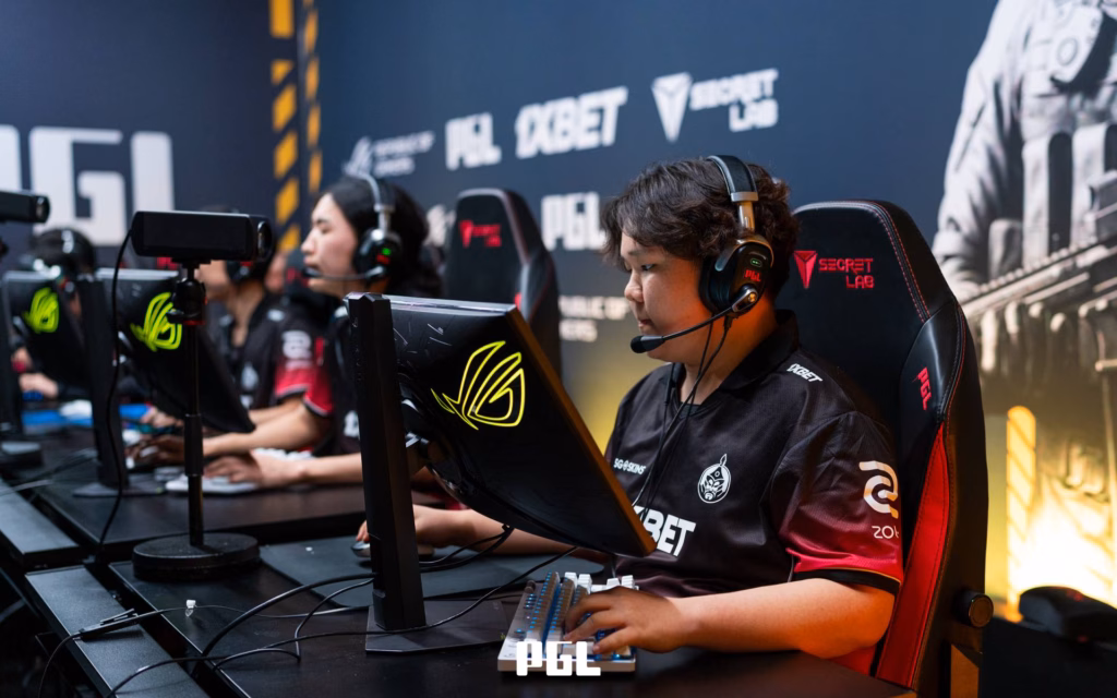 It’s a photo of CS2 players from the team The MongolZ during the Counter-Strike 2 esports tournament PGL Bucharest 2026 - focused during a match, sitting in front of gaming monitors.